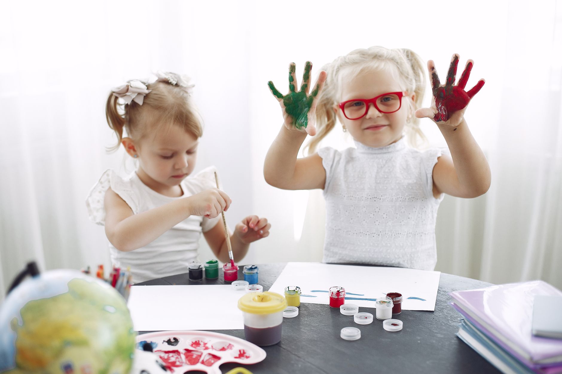 Children creating art with teacher